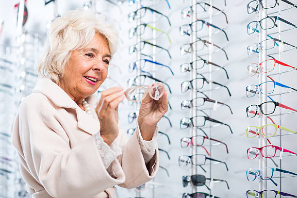 istock Choosing glasses in optician store 512228512