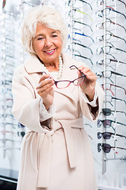 istock Senior woman in optical shop 512228570
