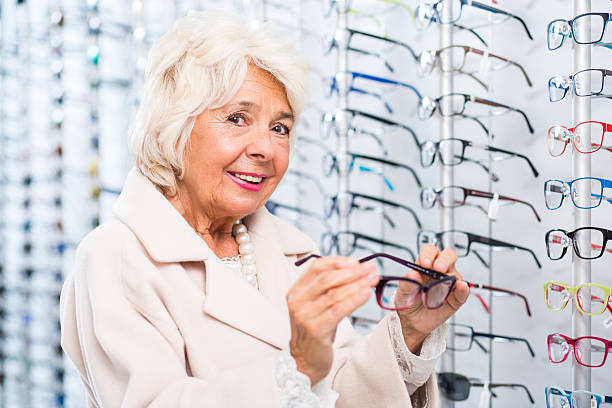 istock Opticians female patient buying glasses 512229268