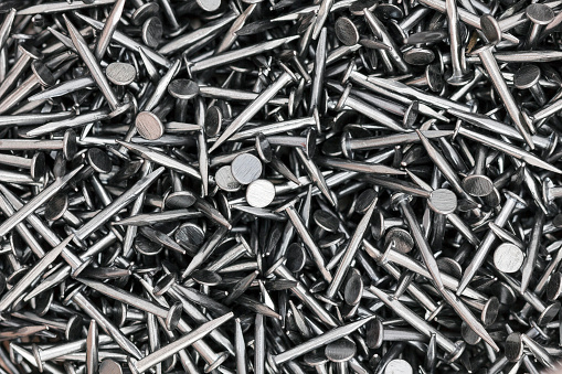 Background of silver construction carpenter's nails macro