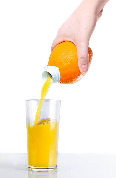 istock Orange juice is poured into a glass 512229694