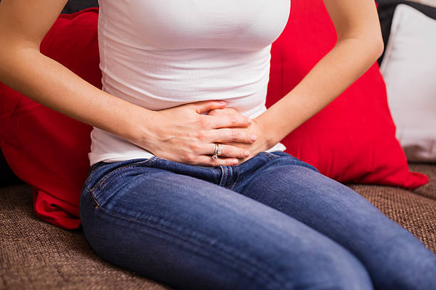 istock Woman holding her stomach 512230204