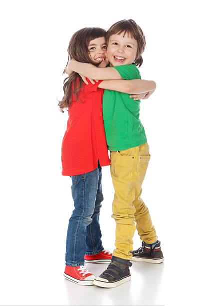 Adorable boy and girl hugging, isolated on white