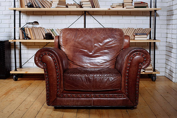 istock Classic Brown leather armchair in  library 512231552