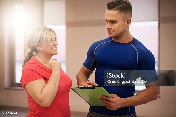 Workout With Couch At Fitness Club Stock Photo - Download Image Now - Fitness Instructor, Clipboard, Active Lifestyle