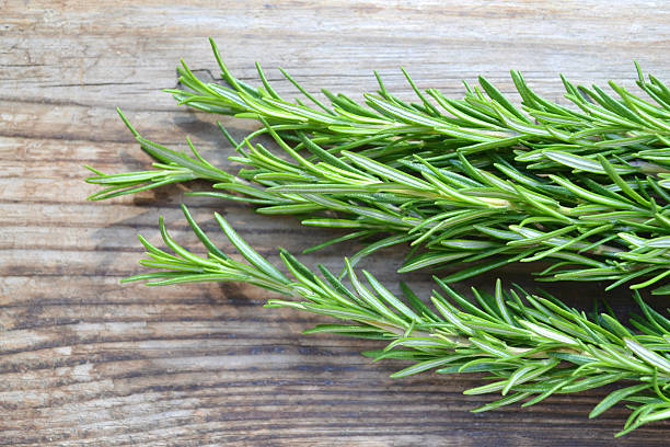 istock Fresh rosemary herb on wooden table 512248409