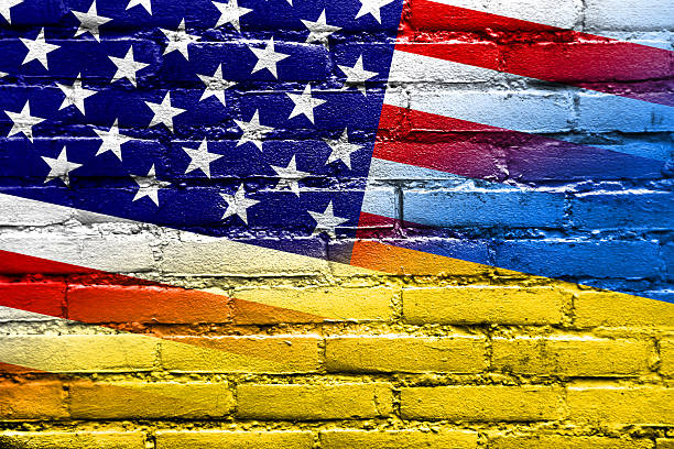 Ukraine and USA Flag painted on brick wall stock photo