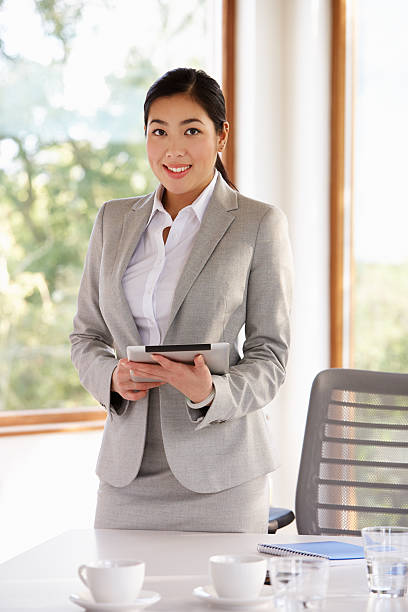 istock Businesswoman Standing In Boardroom With Digital Tablet 512248771