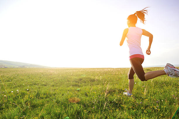 istock Runner athlete running on sunrise/sunset grass field 512250987