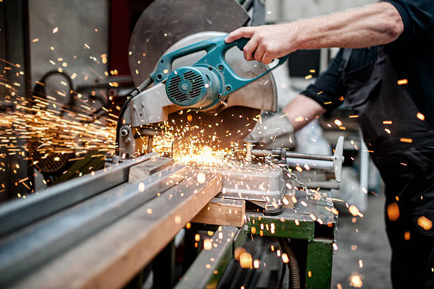 man, worker using a sliding compound mitre saw stock photo