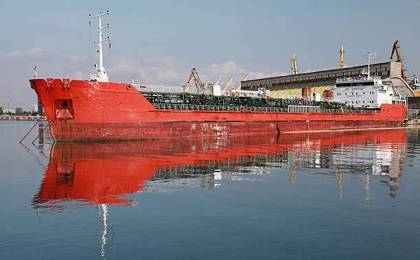 istock Red industrial cargo ship moored in port 512253401