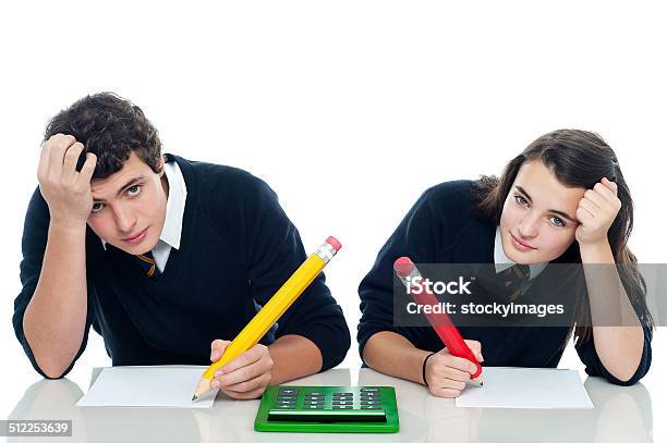Confused Students Holding Their Heads During Examination Stock Photo - Download Image Now