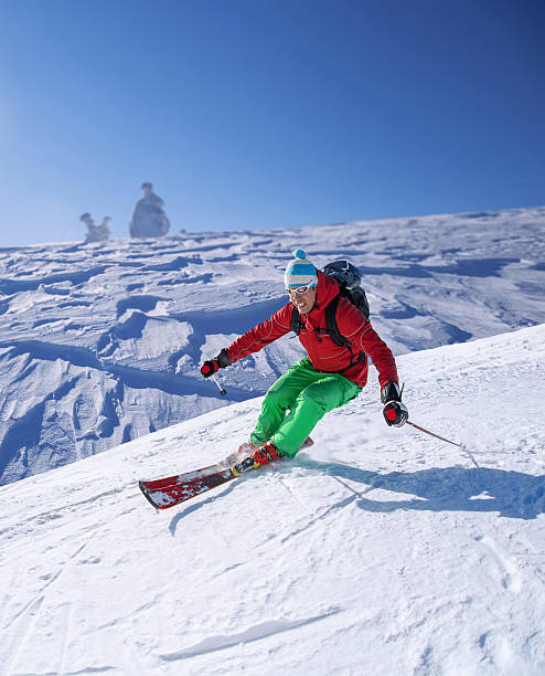 istock Skier skiing downhill in high mountains against sunset 512254437