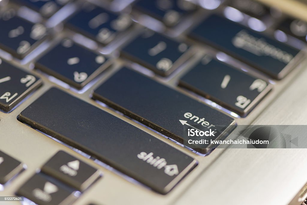 enter keyboard on notebook computer enter keyboard on old notebook computer Alphabet Stock Photo