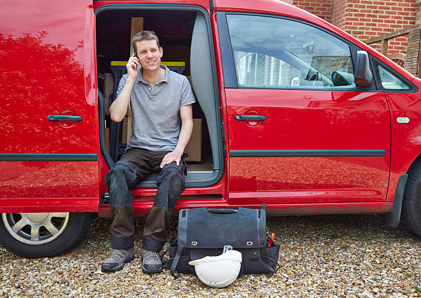 istock Tradesman sitting in van talking on cell phone 512273007