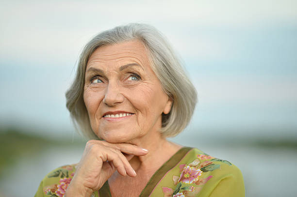 istock Elderly woman near lake 512273172