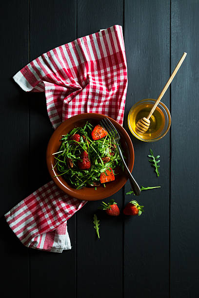 istock Useful strawberry salad with arugula nuts and honey 512274500