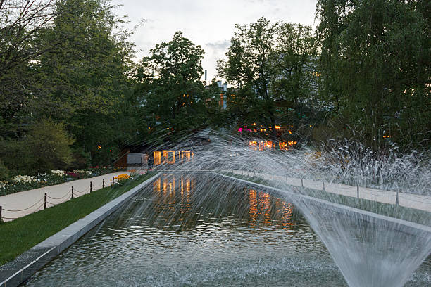 istock pond with fountain among flowers in park 512275366