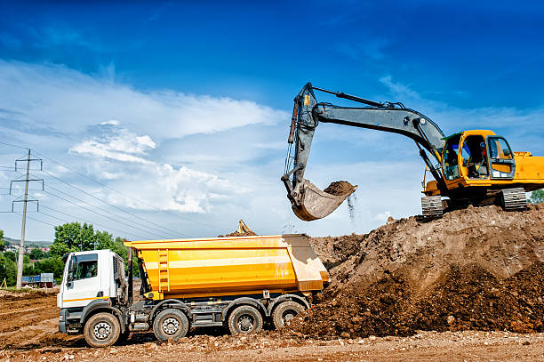 istock Industrial truck loader excavator and bulldozer moving earth 512275513