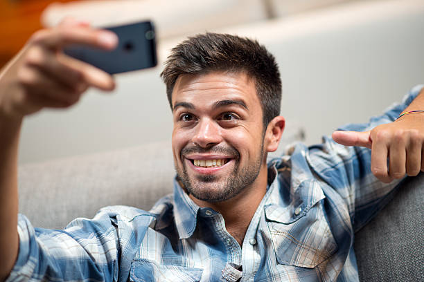istock Young man taking selfie with phone 512275605