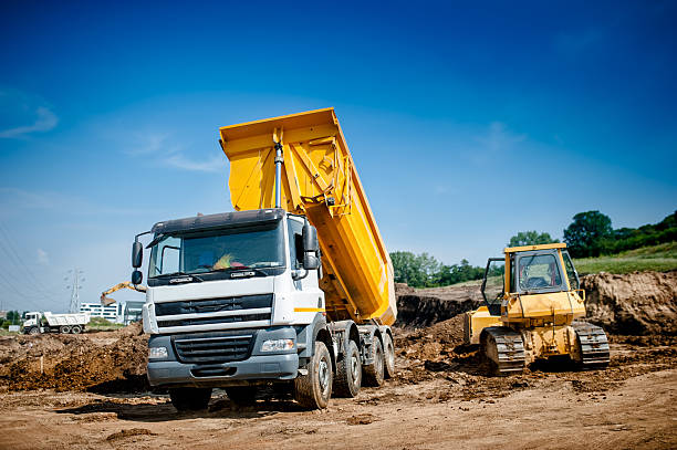 istock dumper truck and bulldozer at highway road construction site 512275621