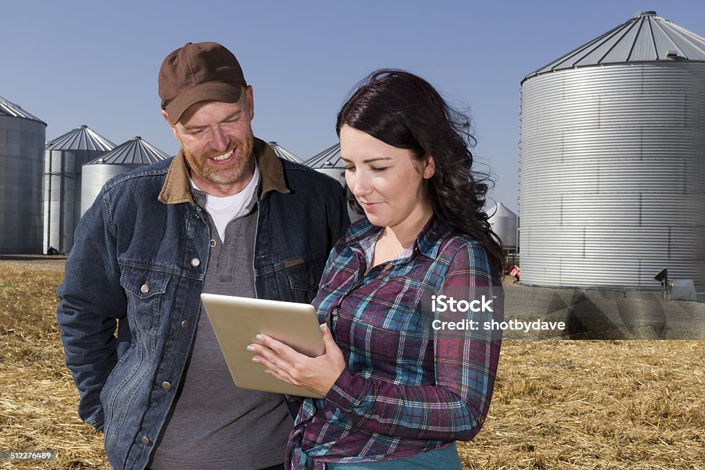 Farmer Couple and Technology A royalty free image from the farming industry of a farmer couple using a tablet computer. Farmer Stock Photo
