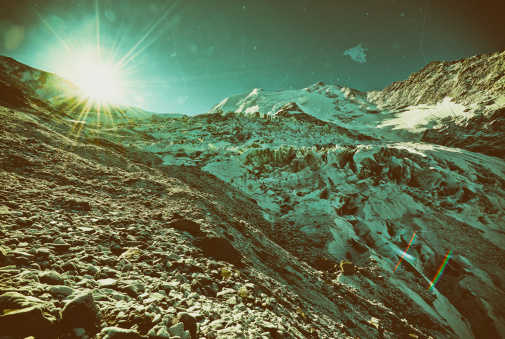 Toned, cross-processed photo of an lpine glacier. Dirt and scratches added.