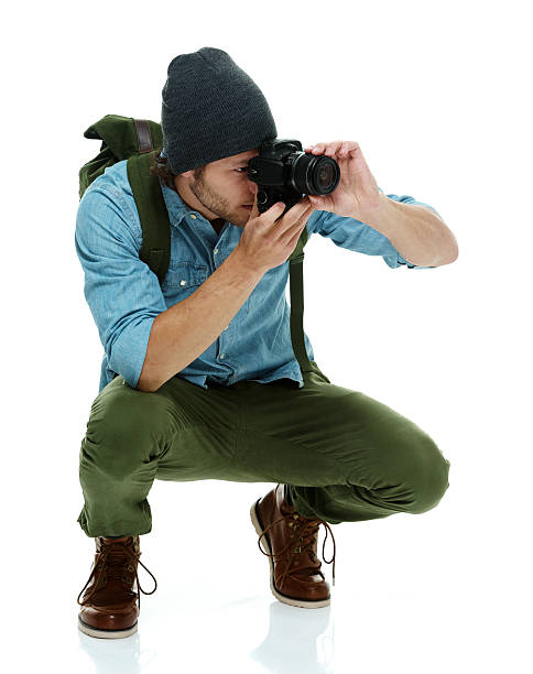 istock Photographer in action with slr camera 512278503