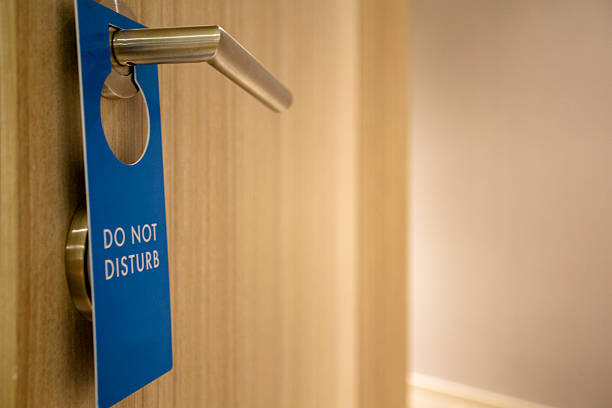 istock 'do not disturb' tag hanging on the door knob 512283046