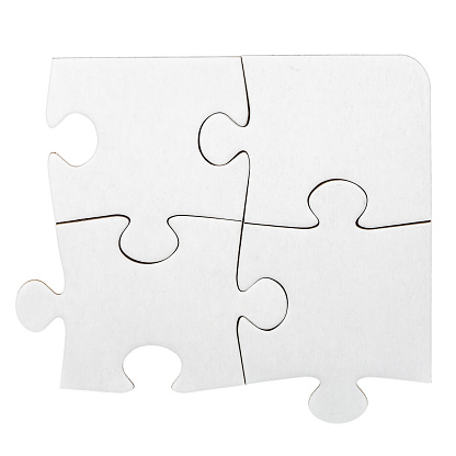 Four cardboard jigsaw puzzle pieces isolated on white