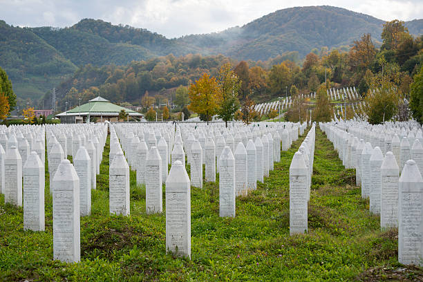 Srebrenica massacre and cemetery in Bosnia Potočari, Bosnia and Herzegovina - October 11, 2013: Some of the more than 6000 graves at the Srebrenica-Potočari Genocide Memorial and Cemetery, where the remains of Bosnian Muslims killed by Bosnian Serbs have been laid to rest. ethnic cleansing stock pictures, royalty-free photos & images