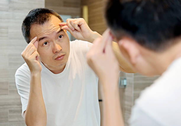 istock Young man morning skin care at bathroom. 512286636