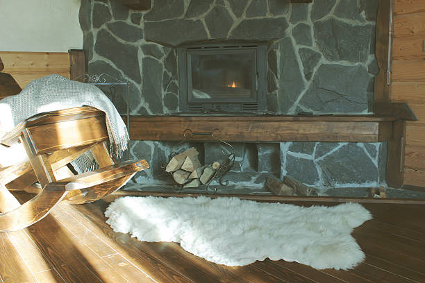 istock Stone hearth fireplace with wooden rocking chair 512286674