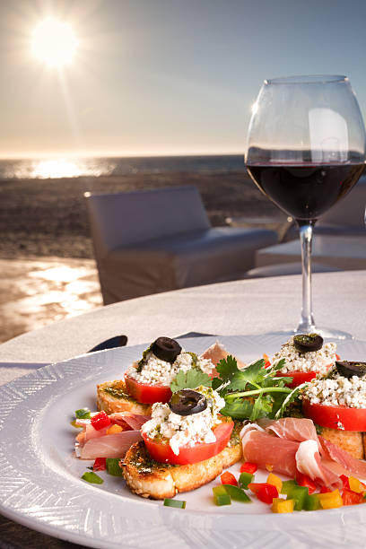 istock Crumbly Cheese and Tomato Ham Crostini Seaside with Red Wine 512287424