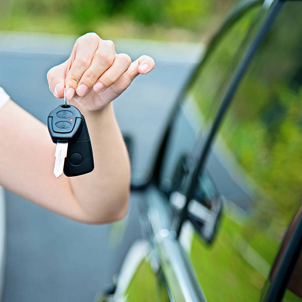 istock Woman hand holding new car key 512288140