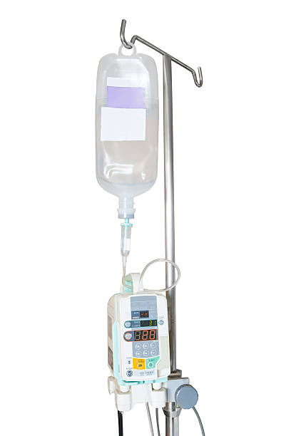 Isolated infusion pump and IV hanging on pole Isolated infusion pump and IV hanging on pole with clipping path saline drip stock pictures, royalty-free photos & images