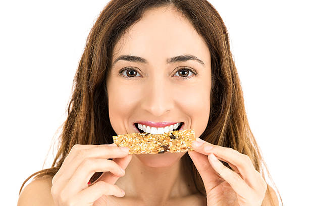 istock Woman eating energy bar 512289570