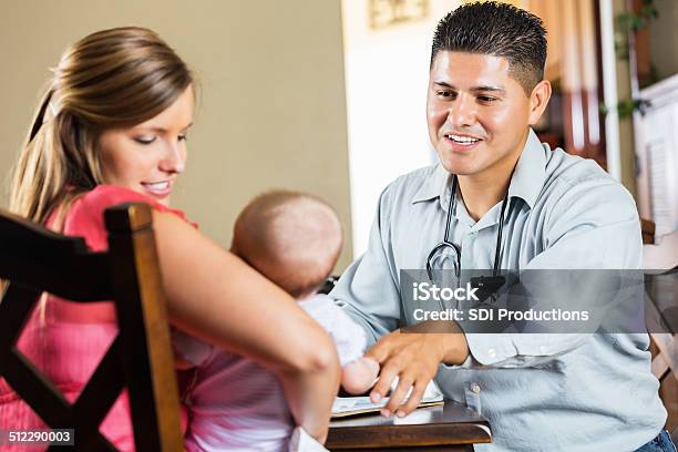 Mother And Peidatrician Examining Young Baby With Cystic Fibrosis Stock Photo - Download Image Now