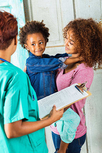 istock Ethiopian child smiling at doctor or nurse during check up 512290057