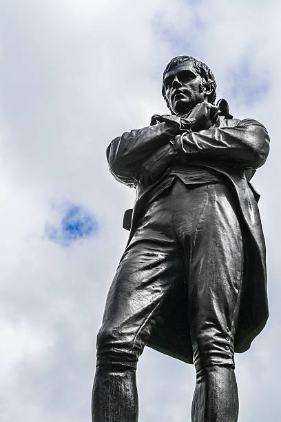 istock Statue of men from black bronze on cloudy sky 512290999
