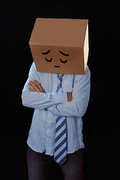 istock messy businessman with carboard box on head sad expression draw 512291103