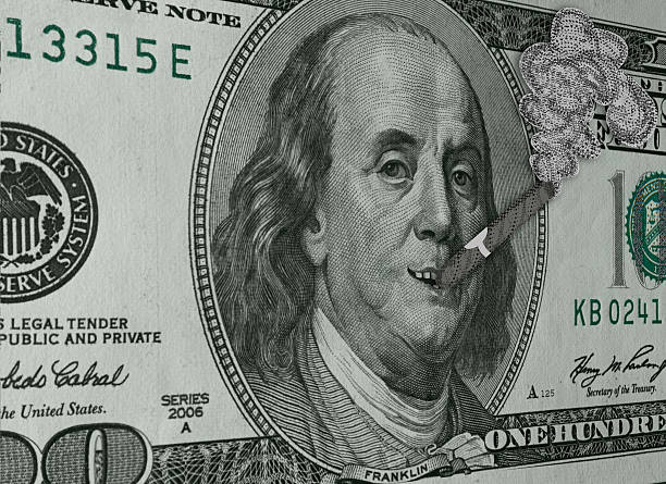 Ben Franklin Smoking Cigar and Smiling on Hundred Dollar Bill stock photo