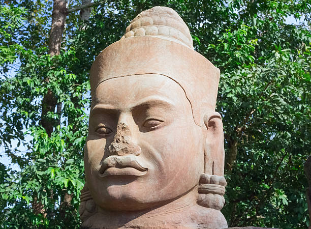 Ancient stone face near Bayon Temple, Angkor Wat complex, Siem Reap, Cambodia. UNESCO World Heritage Site.