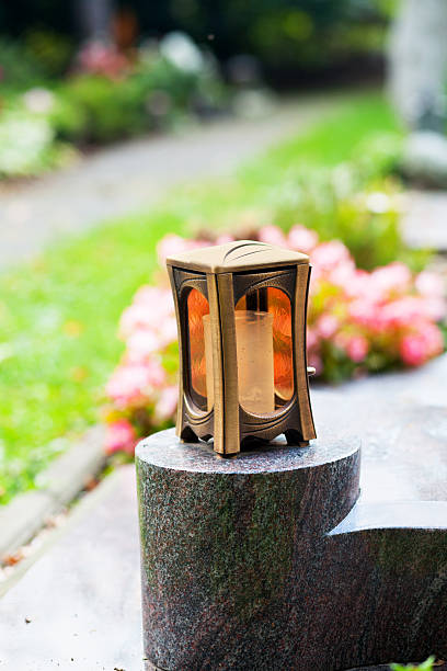 istock Metal lantern with candle on tombstone 512294287
