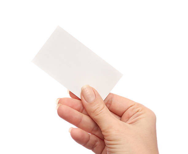 istock Female hand holds business card on white background 512294656
