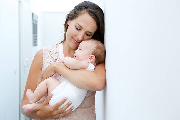 istock Loving mother holding newborn child 512294711