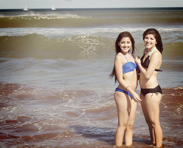 istock two girls posing in the water 512298554