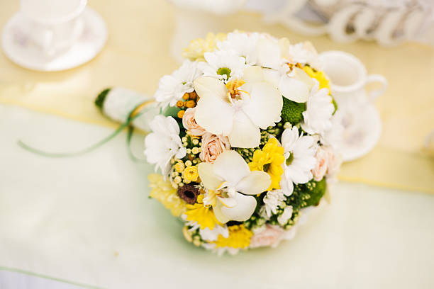 istock White orchids and yellow roses bride bouquet 512301360