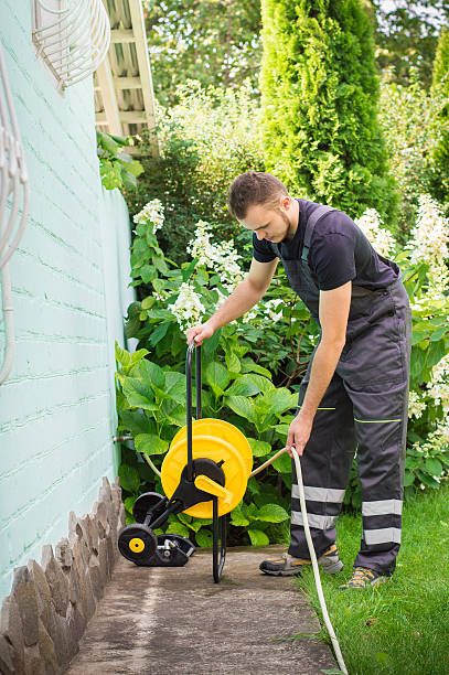 istock Gardener with a hose for watering 512301792