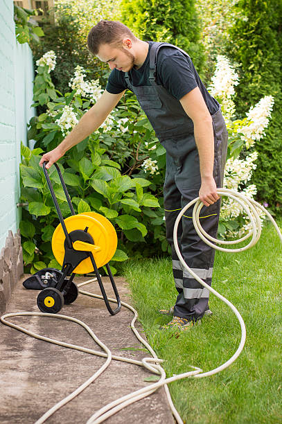 istock Gardener with a hose for watering 512302758